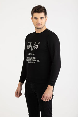 Front view of a man wearing a black Versace 19.69 Abbigliamento Sportivo sweatshirt with silver 19V69 Milano Italia linear logo.