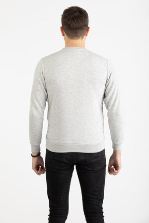 Man wearing a heather grey Versace 19.69 sweatshirt with black linear 19V69 Italia branding.