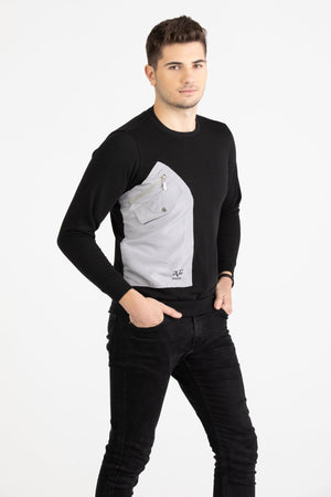 Man wearing a black Versace 19.69 sweatshirt featuring a large grey nylon utility pocket with zipper and snap details.