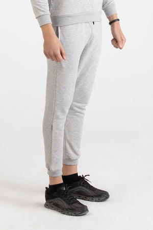 Close-up of heather grey Versace 19.69 joggers featuring a drawstring waist and small 19V69 logo on the thigh.