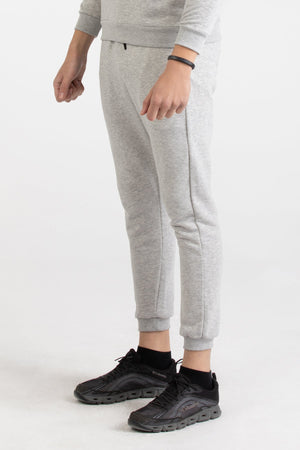 Close-up of heather grey Versace 19.69 joggers featuring a drawstring waist and small 19V69 logo on the thigh.