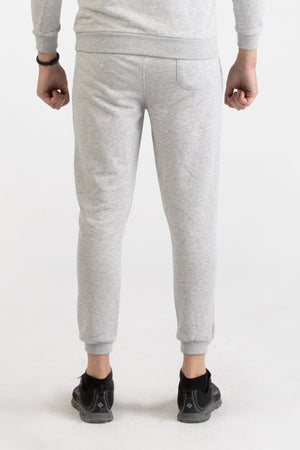 Close-up of heather grey Versace 19.69 joggers featuring a drawstring waist and small 19V69 logo on the thigh.