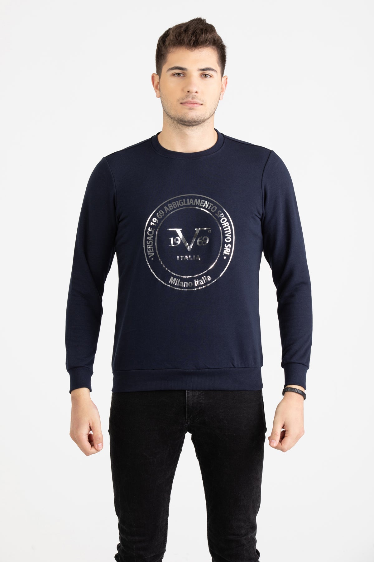 Close-up view of navy blue Versace 19.69 joggers featuring a drawstring waist and small silver 19V69 Italia logo on the thigh.
