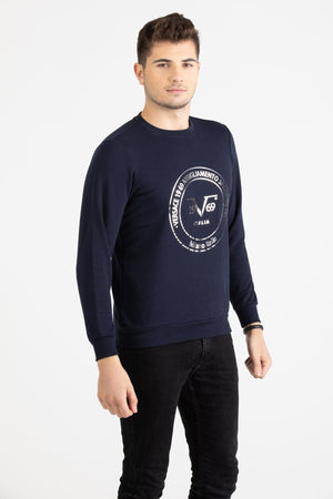 Close-up view of navy blue Versace 19.69 joggers featuring a drawstring waist and small silver 19V69 Italia logo on the thigh.