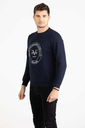 Close-up view of navy blue Versace 19.69 joggers featuring a drawstring waist and small silver 19V69 Italia logo on the thigh.