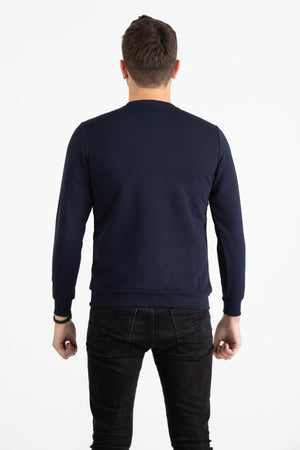 Close-up view of navy blue Versace 19.69 joggers featuring a drawstring waist and small silver 19V69 Italia logo on the thigh.