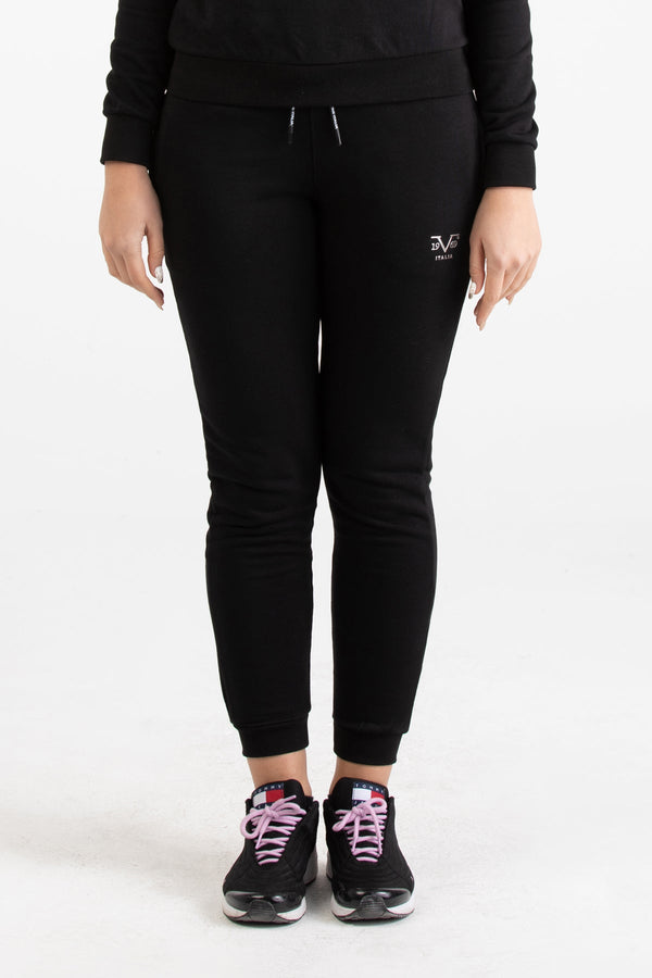 Close-up view of black Versace 19.69 joggers for women featuring a drawstring waist and small silver 19V69 Italia logo on the thigh.