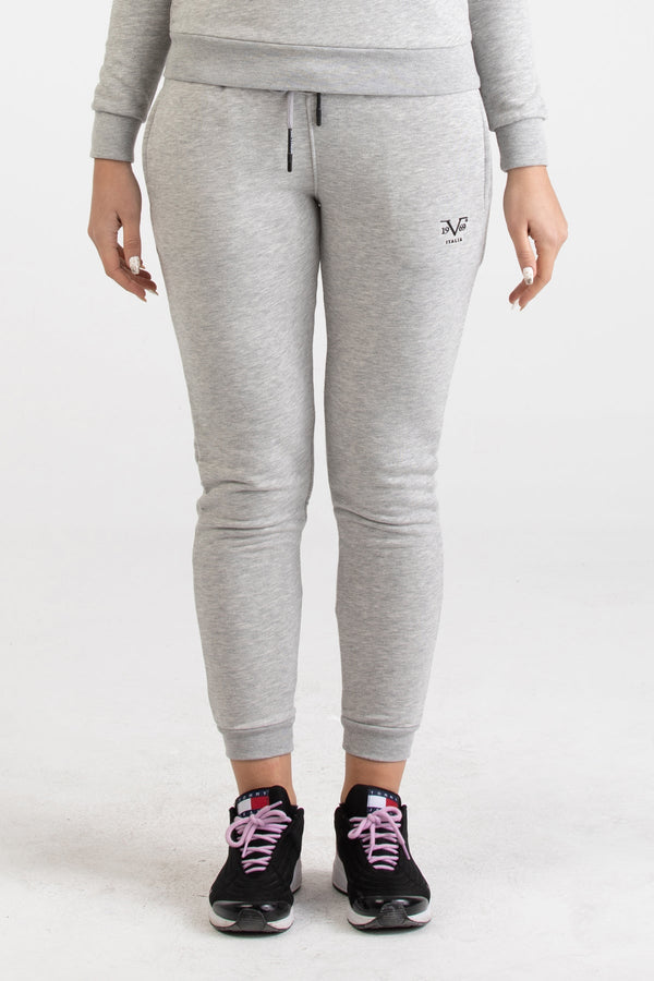 Front view of heather grey Versace 19.69 joggers for women featuring a black 19V69 Italia logo on the thigh and ribbed ankle cuffs.